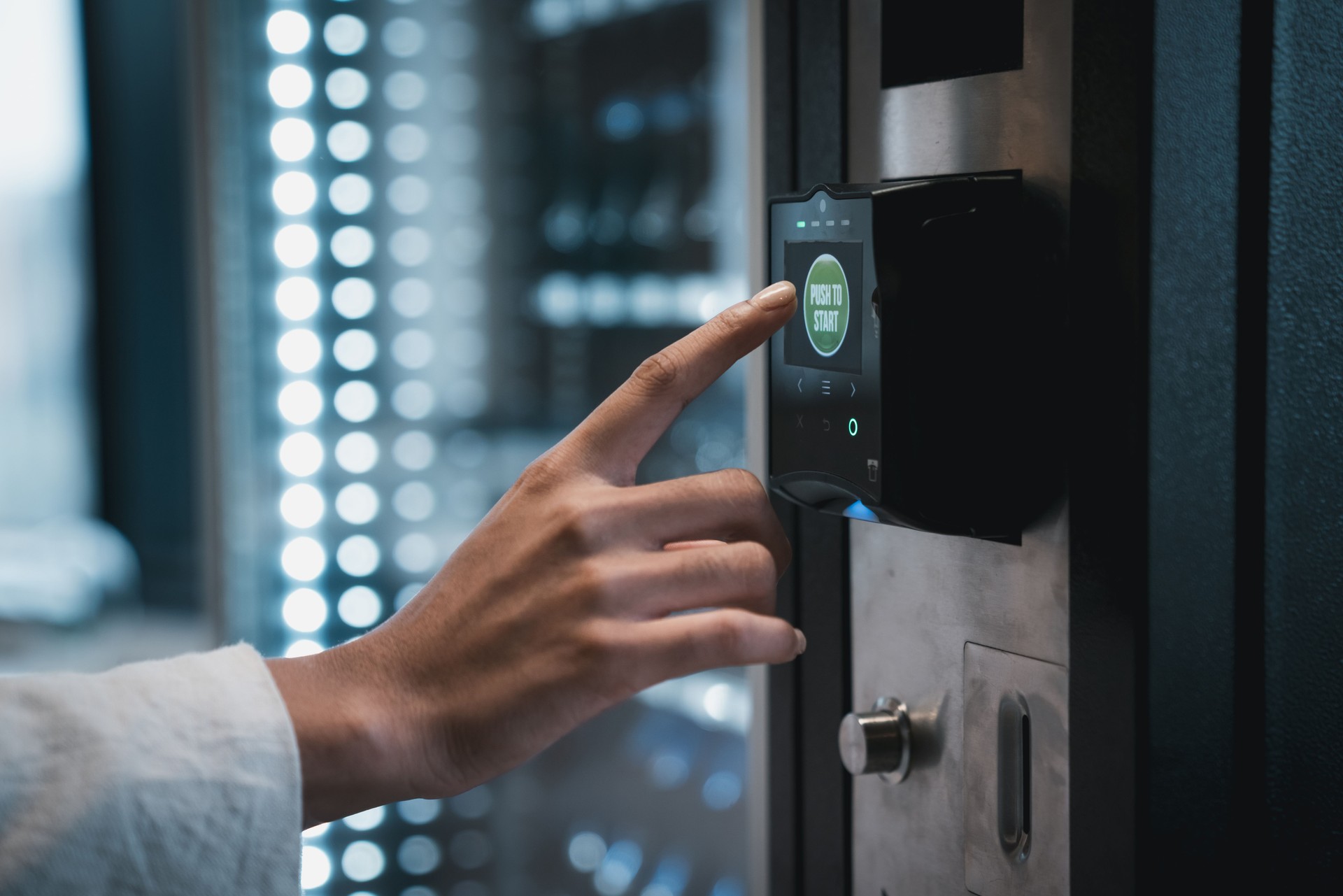 Close up hand of woman pushing button on vending machine for choosing a snack or drink. Small business and consumption concept.